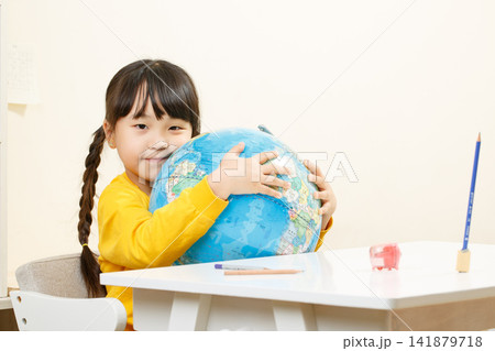 Asian little girl hugging globe, learning geography, curious child exploring world, education concept 141879718