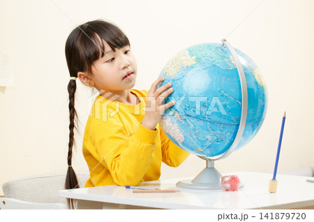 Asian little girl hugging globe, learning geography, curious child exploring world, education concept Asian little girl hugging globe, learning geography, curious child exploring world, education concept 141879720