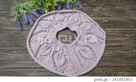 Knitted sweater collar in progress, using knitting needles and stitch markers. 141881953