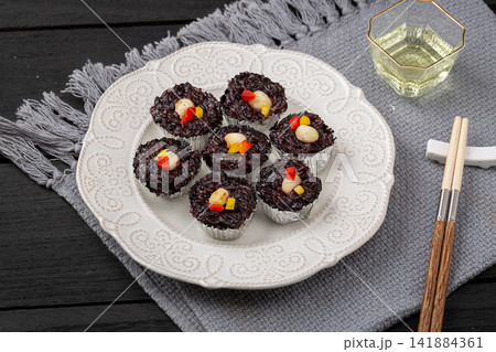 steamed black rice cake fa gao topped with white nuts 141884361