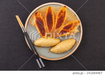 pan fried cornmeal potstickers with crispy golden lace crust 141884467