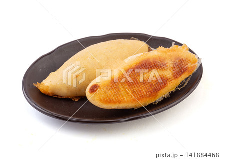 pan fried cornmeal potstickers with crispy golden lace crust 141884468