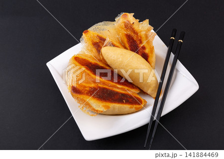 pan fried cornmeal potstickers with crispy golden lace crust 141884469
