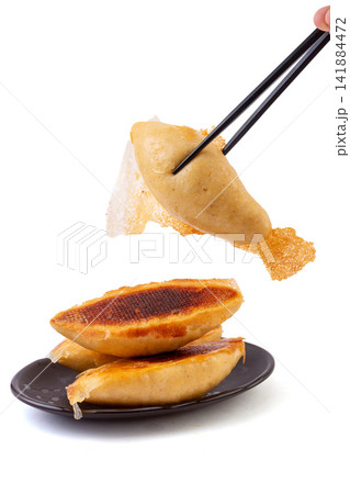 pan fried cornmeal potstickers with crispy golden lace crust 141884472