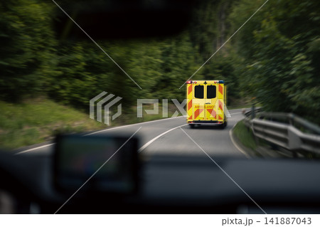 Emergency Ambulance Speeding on Road with Motion Blur Emergency Ambulance Speeding on Road with Motion Blur 141887043