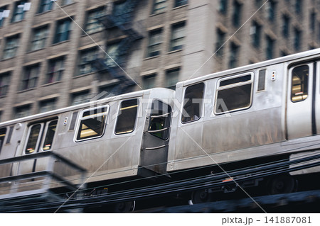 Train on elevated railway above street in downtown Chicago Train on elevated railway above street in downtown Chicago 141887081