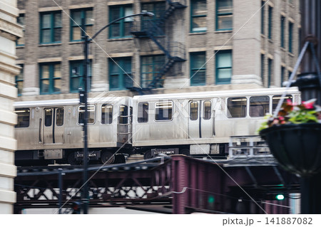 Train on elevated railway above street in downtown Chicago Train on elevated railway above street in downtown Chicago 141887082