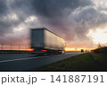 Motion blurred truck driving fast on highway at sunset 141887191