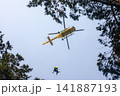Rescuer on rope under a flying helicopter of emergency medical service 141887193