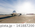 Front view of airplane taxiing to runway on sunny airport day 141887200