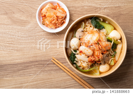 Instant noodle soup with kimchi, bok choy, champignon mushroom, quail egg and Tteokbokki Instant noodle soup with kimchi, bok choy, champignon mushroom, quail egg and Tteokbokki 141888663