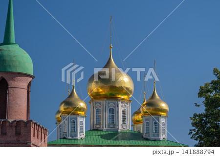 Golden domes shine brilliantly under the clear blue sky at the Cathedral of the Assumption in Tula Russia 141888794