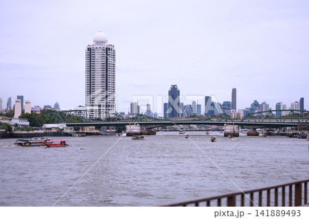 View of motorboats and passenger boats navigating the Chao Phraya River near Memorial Bridge 141889493