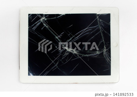 Broken tablet with cracked screen showing technology failure Broken tablet with cracked screen showing technology failure 141892533