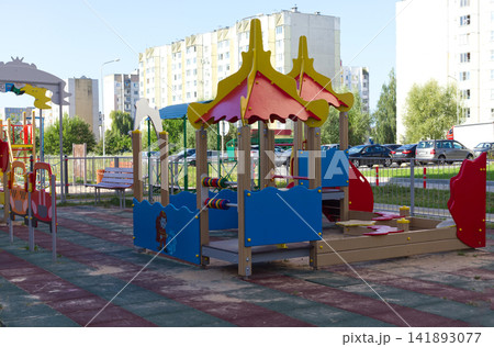 Bright Modern Kids Play Complex near Multi Story Apartment Buildings 141893077