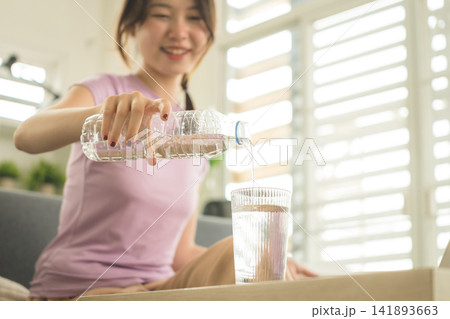 Young Asian Woman Working Online, Relaxing and Practicing Self Care During Daily Life at Home 141893663