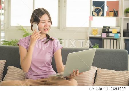 Young Asian Woman Working Online, Relaxing and Practicing Self Care During Daily Life at Home 141893665