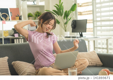 Young Asian Woman Working Online, Relaxing and Practicing Self Care During Daily Life at Home Young Asian Woman Working Online, Relaxing and Practicing Self Care During Daily Life at Home 141893671