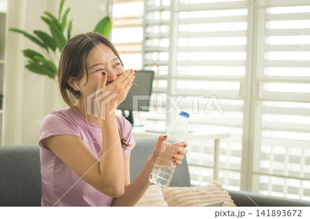 Young Asian Woman Working Online, Relaxing and Practicing Self Care During Daily Life at Home 141893672