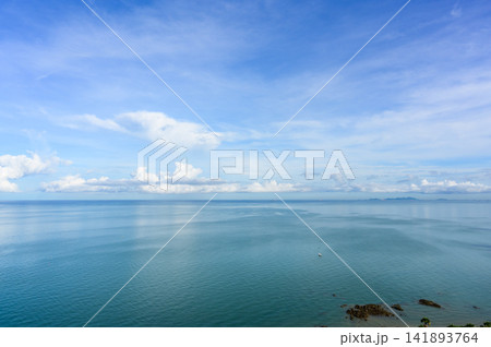 White clouds in sky over seascape on sunny day in Pattaya, Thailand. beautiful landscape of tropical sea water with reflection of sunlight. copy space. 141893764