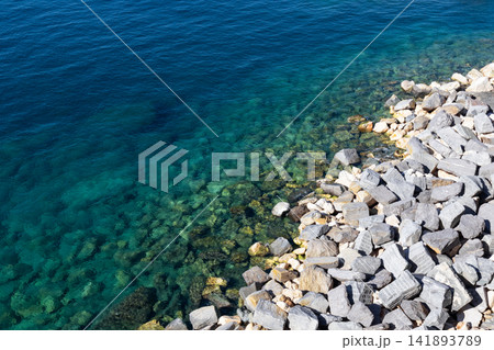 Seawater, contrasting marine and stone textures, steep downward coastal perspective Seawater, contrasting marine and stone textures, steep downward coastal perspective 141893789