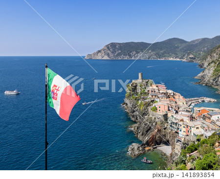 Italian flag in Vernazza, Italy with national flag balanced against coastal village 141893854