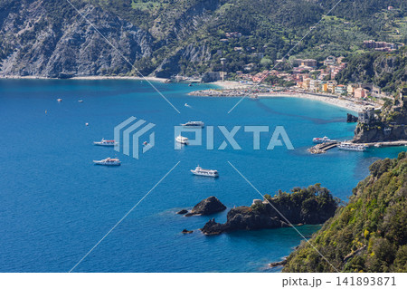 Passenger boat in Monterosso al Mare, Italy with dense boat traffic across open water Passenger boat in Monterosso al Mare, Italy with dense boat traffic across open water 141893871