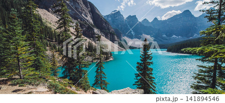Turquoise Mountain Lake with Pine Forest and Rocky Peaks 141894546