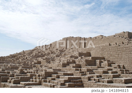 Ancient Adobe Pyramid Ruins Under Blue Sky 141894815