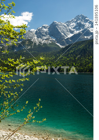 Travel landscape of Eibsee lake beach and Zugspitze peak in Alps, Bavaria Germany, scenic summer nature panorama with forest Travel landscape of Eibsee lake beach and Zugspitze peak in Alps, Bavaria Germany, scenic summer nature panorama with forest 141895106