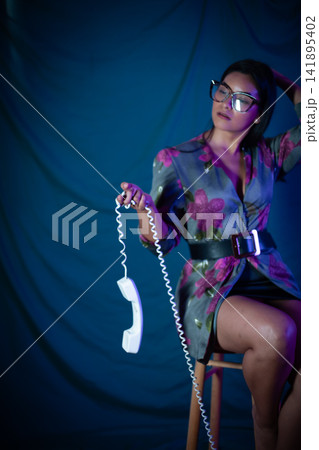 Woman holding phone receiver communicating vintage style 141895402