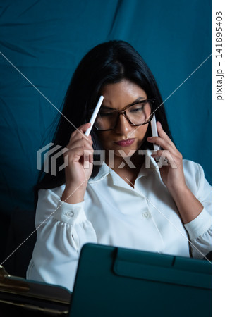 Business woman multitasking, thinking while talking on phone Business woman multitasking, thinking while talking on phone 141895403