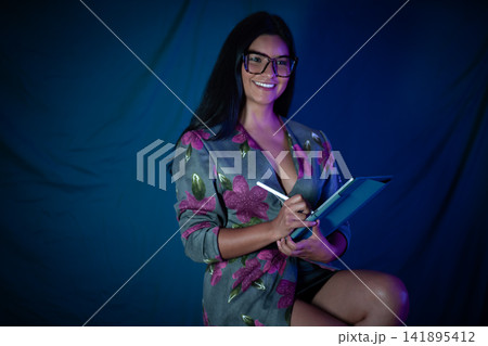 Smiling woman using tablet creating digital artwork Smiling woman using tablet creating digital artwork 141895412