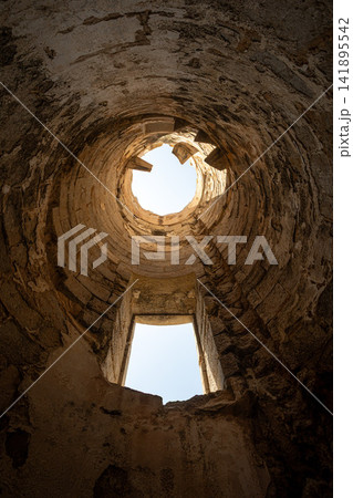 Looking up the crumbling interior of an abandoned historic lighthouse tower in Ibiza 141895542