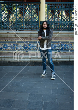 Young man standing in front of morisco kiosk Young man standing in front of morisco kiosk 141895569