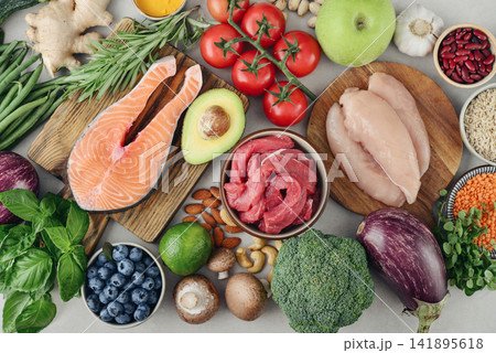 Top view of raw whole foods for Mediterranean diet, clean eating and nutritious meal planning. Top view of raw whole foods for Mediterranean diet, clean eating and nutritious meal planning. 141895618