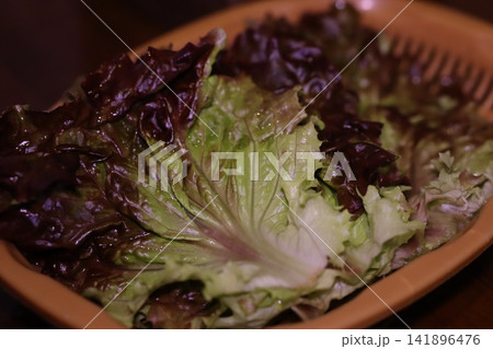 Fresh Mixed Leafy Greens in Terracotta Bowl Fresh Mixed Leafy Greens in Terracotta Bowl 141896476
