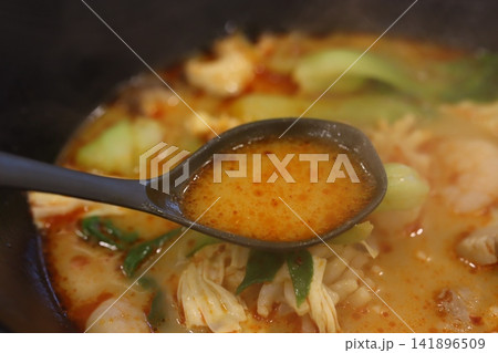 Spiced Soup Spoon Over Hot Pot Dish Spiced Soup Spoon Over Hot Pot Dish 141896509