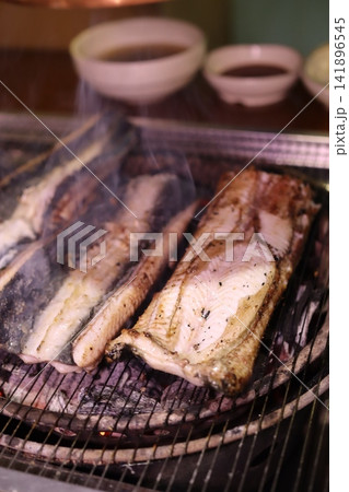 Grilled Fish on Charcoal Grill with Smoke Grilled Fish on Charcoal Grill with Smoke 141896545