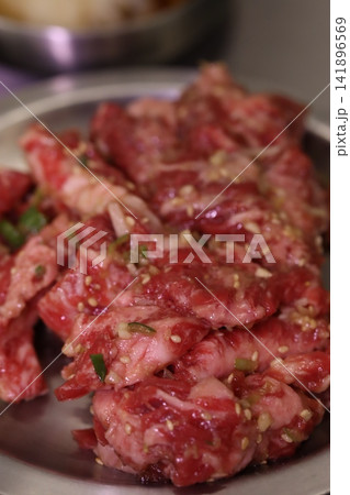Marinated Raw Beef Slices with Sesame Seeds Marinated Raw Beef Slices with Sesame Seeds 141896569
