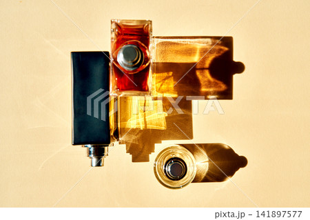 Perfume bottles creating abstract shadows and light reflections Perfume bottles creating abstract shadows and light reflections 141897577