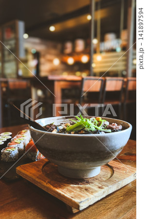 Japanese Ramen Noodle Soup Bowl with Fresh Sushi Rolls in Restaurant Japanese Ramen Noodle Soup Bowl with Fresh Sushi Rolls in Restaurant 141897594