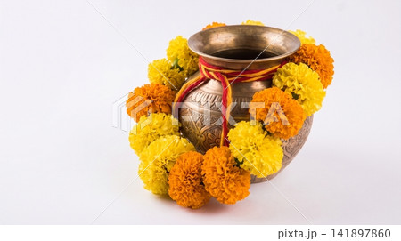 Traditional brass kalash pot decorated with marigold flower garland marigold traditional festival cultural ceremonial auspicious celebration offering blessing tradition religious botanical 141897860