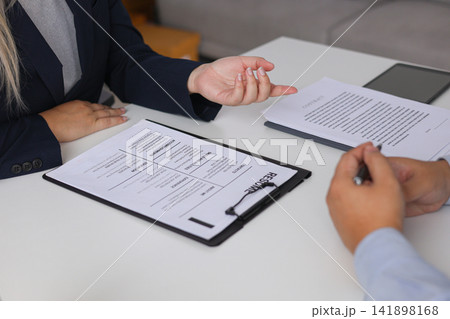 Close-up Of Job Interview and Resume Two Professional Discussing Career Experience and Qualifications. 141898168