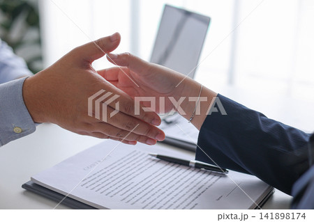 Human Resources Manager Shaking Hands with Candidate After Successful New Job Recruitment. Human Resources Manager Shaking Hands with Candidate After Successful New Job Recruitment. 141898174