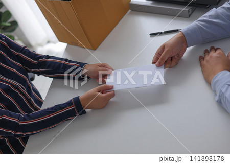 A Manager Providing a Termination Notice or a Separation Packet to a Staff Member. A Manager Providing a Termination Notice or a Separation Packet to a Staff Member. 141898178