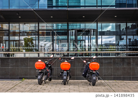 Delivery scooters outside office building, Madrid, Spain Delivery scooters outside office building, Madrid, Spain 141898435
