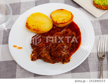Fried pork cheek served on dish with potatoes Fried pork cheek served on dish with potatoes 141898553