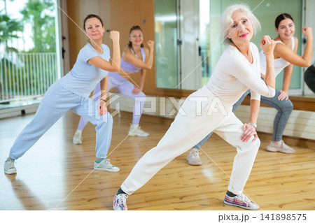 Group are practising arch movement in step jazz dance in fitness gym Group are practising arch movement in step jazz dance in fitness gym 141898575