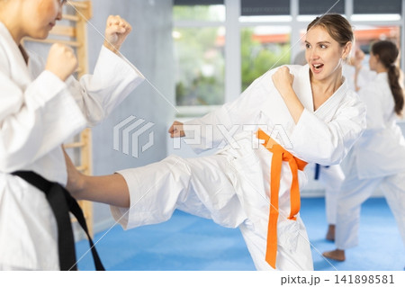 Two women trained to perform basic defensive karate installations and attacking combat techniques 141898581